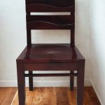 Solid wood dining chair with curved backrest and dark stain finish